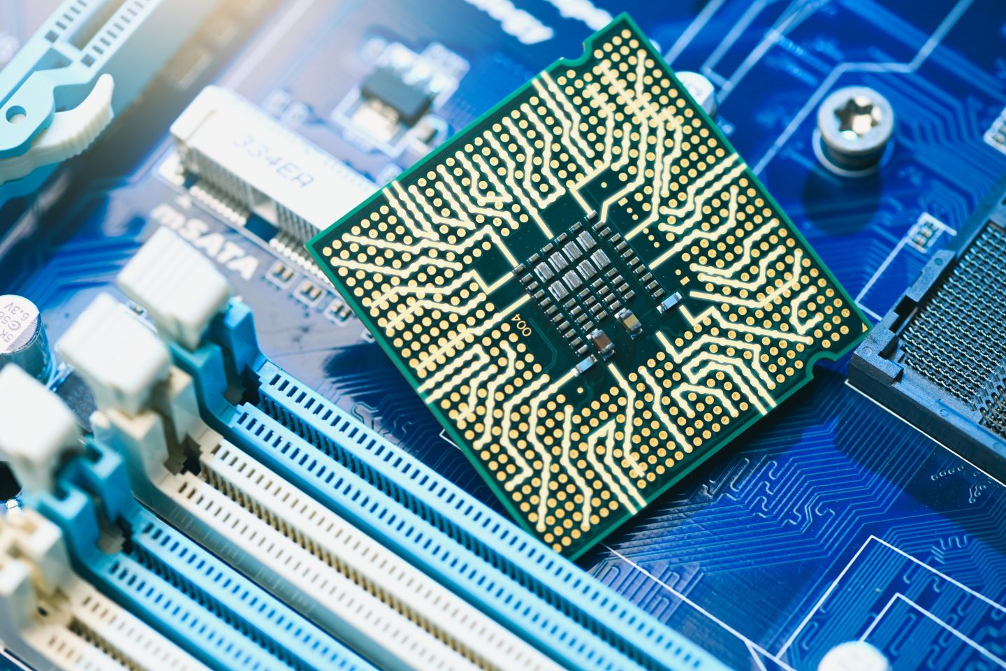 The close-up view of a CPU socket on a computer motherboard. The intricate circuitry and components highlight the precision and complexity of modern technology, ideal for electronics and artificial intelligence.