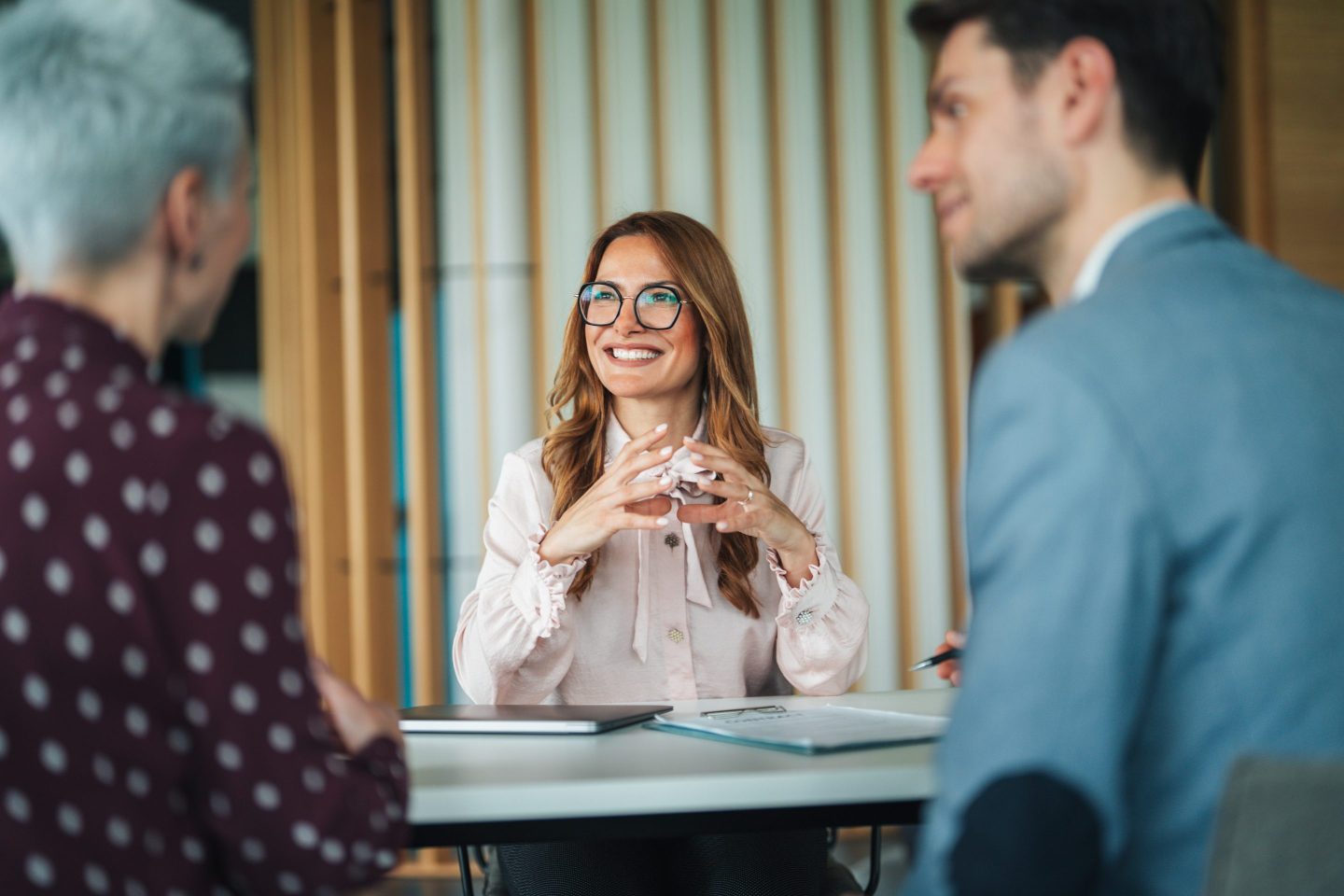 Professional consultation between a customer and service provider in a contemporary office environment. The business meeting illustrating concepts such as client support, business consultation, customer service, financial advice, healthcare discussion, or professional guidance.