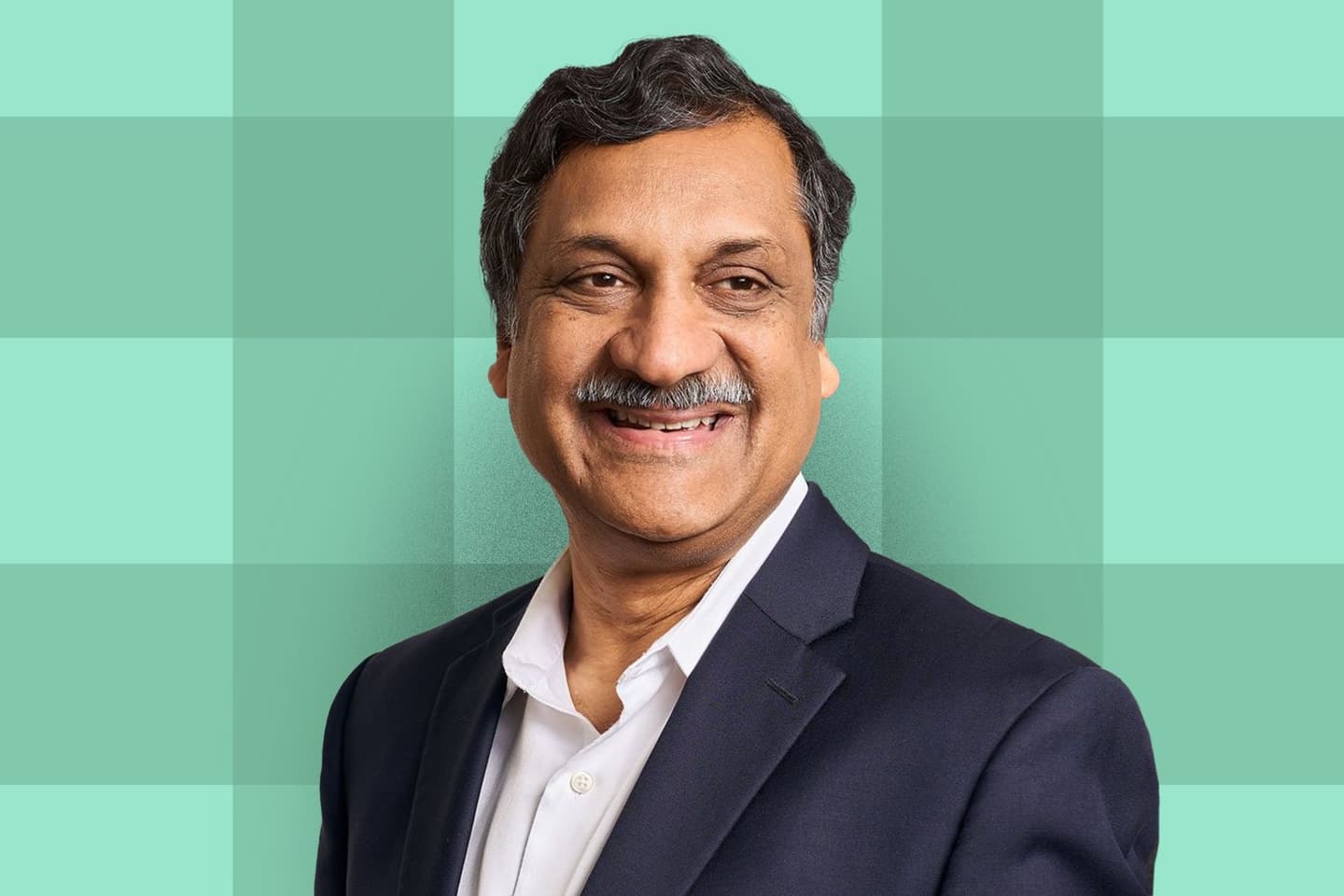 Photo of Anant Agarwal, edX founder, over a light green plaid background.