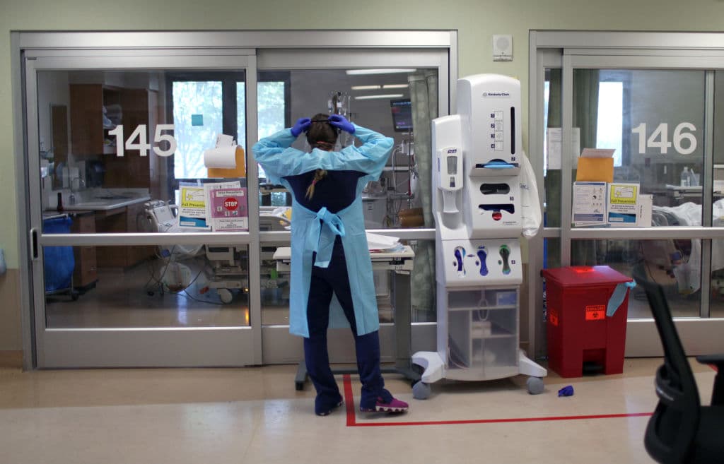 A nurse dons personal protective equipment (PPE) as she prepares to enter the room of a coronavirus COVID-19 patient in the intensive care unit (I.C.U.) at Regional Medical Center, as seen in May 2020 in San Jose, California. (Photo by Justin Sullivan/Getty Images)