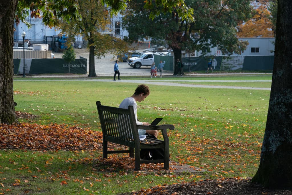 A student uses a laptop computer on the campus of Dartmouth College, as seen in October 2021. (Photographer: Bing Guan—Bloomberg/Getty Images)