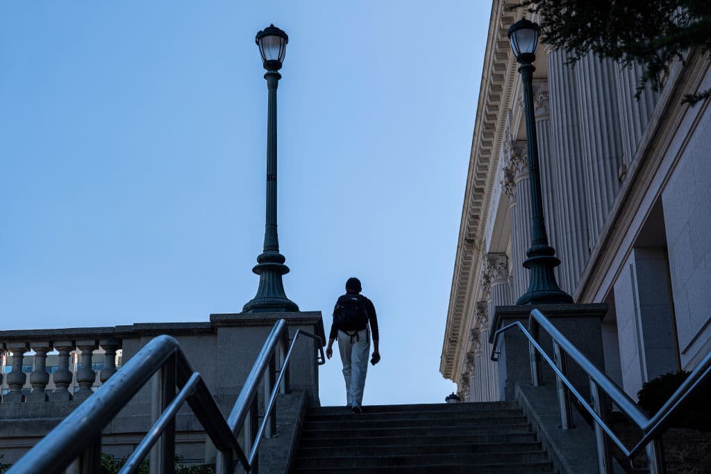 A student walks up steps on the University of California at Berkeley campus as seen in August 2022. (Photographer: David Paul Morris—Bloomberg/Getty Images)