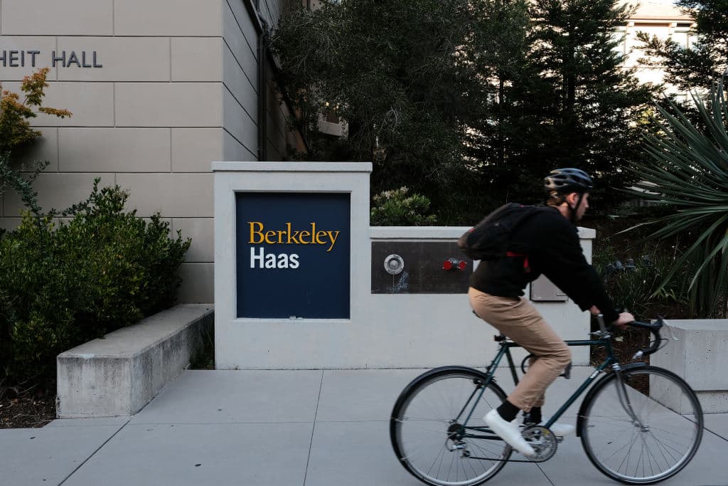 A bicyclist passes Berkeley Haas signage on the University of California, Berkeley campus in Berkeley, California, as seen in August 2022. (Photographer: David Odisho—Bloomberg/Getty Images)