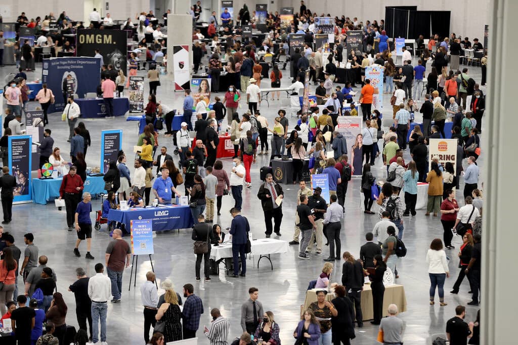 Job seekers visit booths during the Spring Job Fair at the Las Vegas Convention Center, as seen in April 2022. (Photo by K.M. Cannon—Las Vegas Review-Journal/Getty Images)