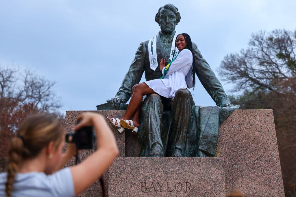 A student takes a graduation photo on the Baylor University campus in Waco, Texas, as seen in December 2022. (Photo by ANDY JACOBSOHN—AFP/Getty Images)