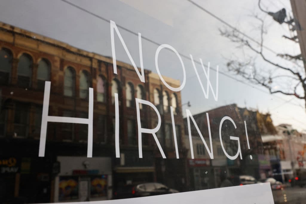 A NOW HIRING sign is posted at a storefront in Toronto, as seen in December 2022. (Lance McMillan—Toronto Star/Getty Images)