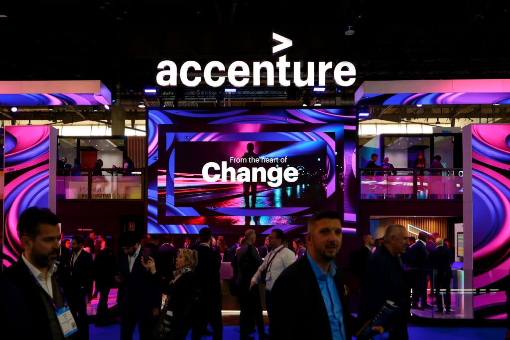 Visitors passing by the Accenture stand during the Mobile World Congress 2023, as seen in March 2023 in Barcelona, Spain. (Photo by Joan Cros—NurPhoto/Getty Images)