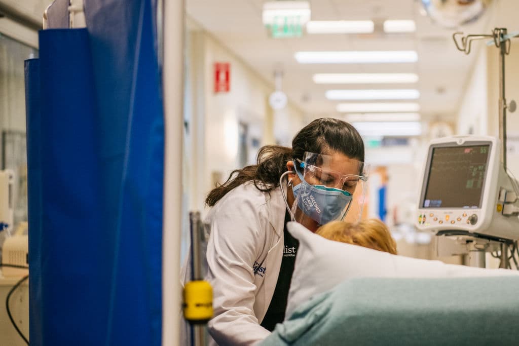 An Emergency Room nurse tends to a patient in a hallway at the Houston Methodist The Woodlands Hospital, as seen in August 2021 in Houston, Texas. (Photo by Brandon Bell/Getty Images)