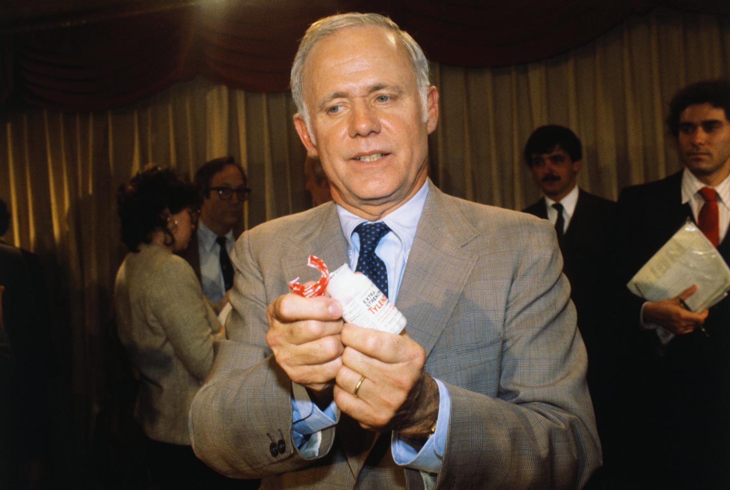 Johnson & Johnson Chairman James Burke displays new preventative Tylenol bottle in November 1982.