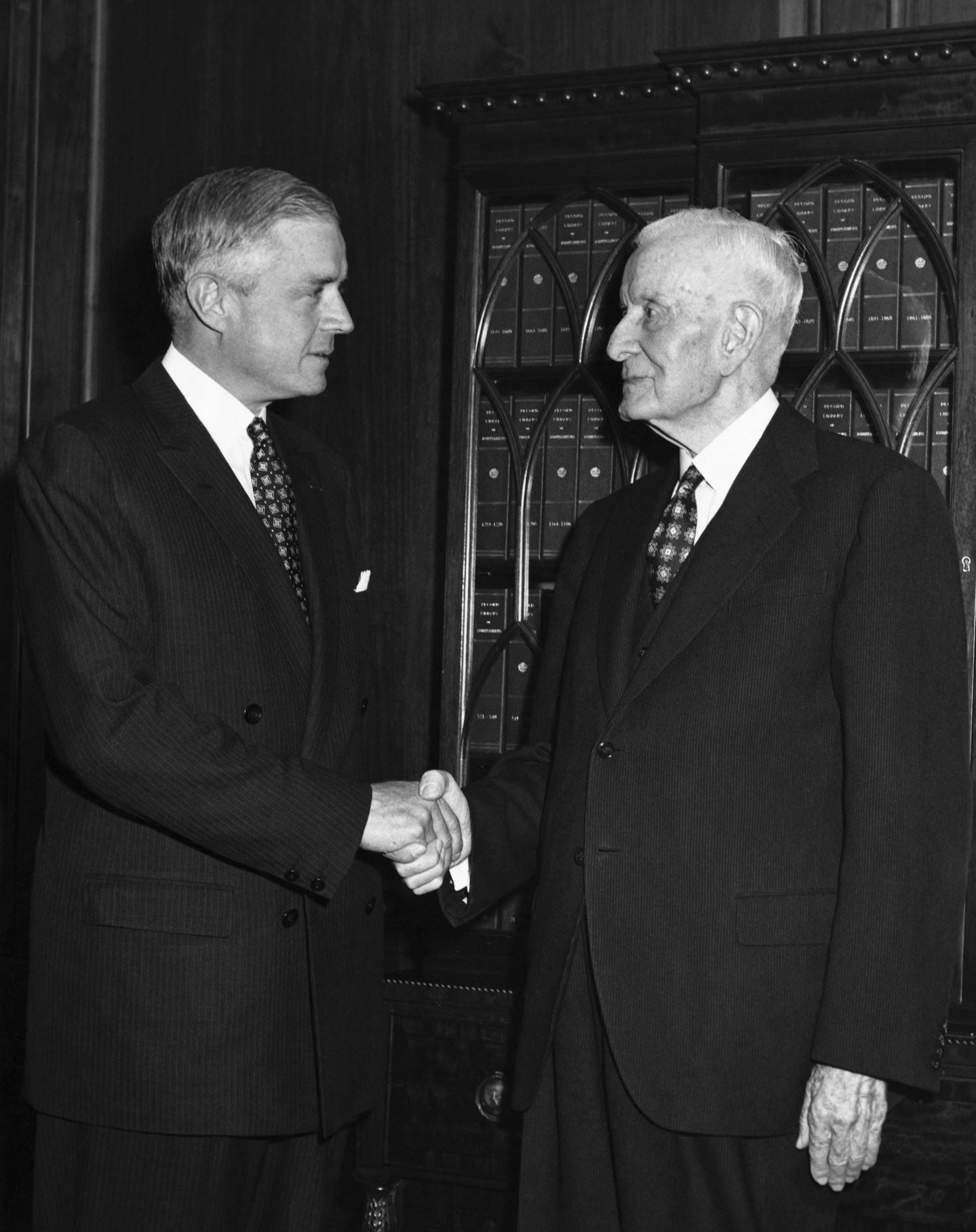 Thomas J. Watson, Jr. (left) receives congratulations from his father, Thomas J. Watson, Sr., after being elected CEO of IBM in 1956.
