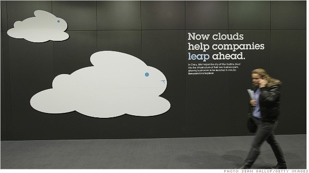 HANOVER, GERMANY - MARCH 05:  A woman speaking on a mobile phone walks past a could computing presentation at the IBM stand the day before the CeBIT 2012 technology trade fair officially opens to the public on March 5, 2012 in Hanover, Germany. CeBIT 2012, the world's largest information technology trade fair, will run from March 6-10, and advances in cloud computing are a major feature this year.  (Photo by Sean Gallup/Getty Images)