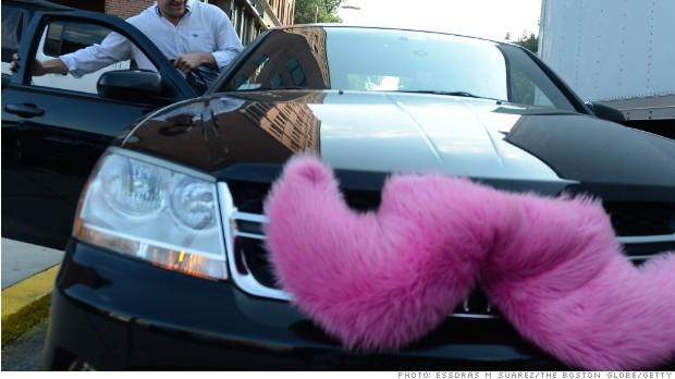 Boston, MA 071613 Hunter Perry (Cq)( a regular Lyft user gets picked up on July 16, 2013 near his office on Harrison Ave. The vehicles participating in the Lyft program wear a pink mustache on their front grille. (Essdras M Suarez/ Globe Staff)/ MET