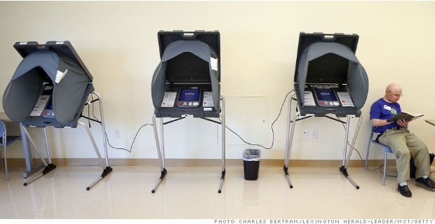 Election Judge Robert Hutchens read a history book between voters at the Douglas-Washington precinct in a room at the Bluegrass Community and Technical College Newtown campus, in Lexington, Ky., Tuesday, May 20, 2014. (Charles Bertram/Lexington Herald-Leader/MCT)