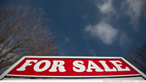 A for sale sign stands outside a home in Princeton, Illinois, U.S., on Wednesday, Jan. 22, 2014. The National Association of Realtors is scheduled to release its monthly existing-home sales figures on Thursday, Jan. 23, 2014. Photographer:  Daniel Acker/Bloomberg