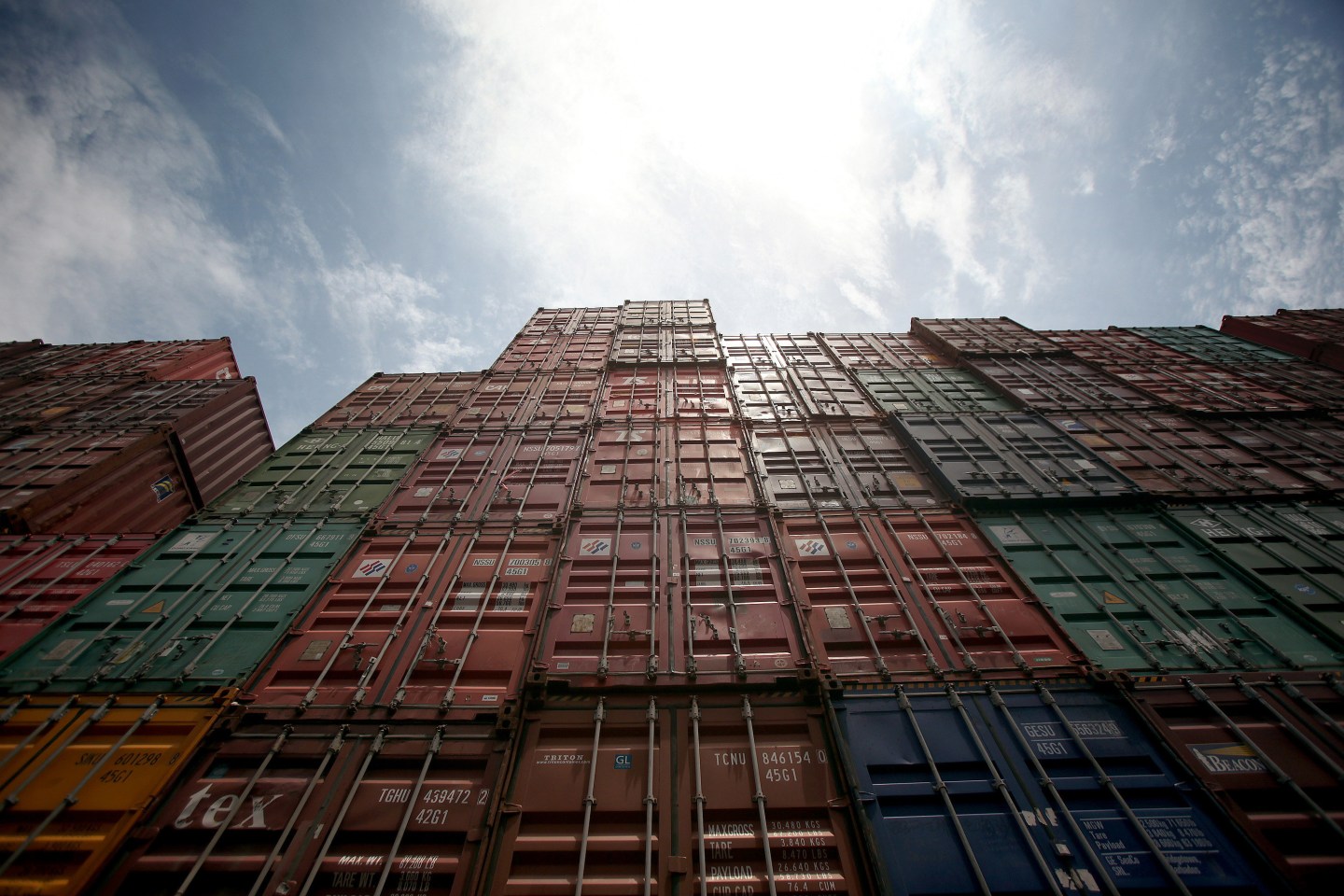 Containers are stacked in the yard of a shipment company, outside the Bangkok port on Saturday, June 23, 2012. Photographer: Dario Pignatelli/Bloomberg *** Local Caption *** Bangkok Port Import Export