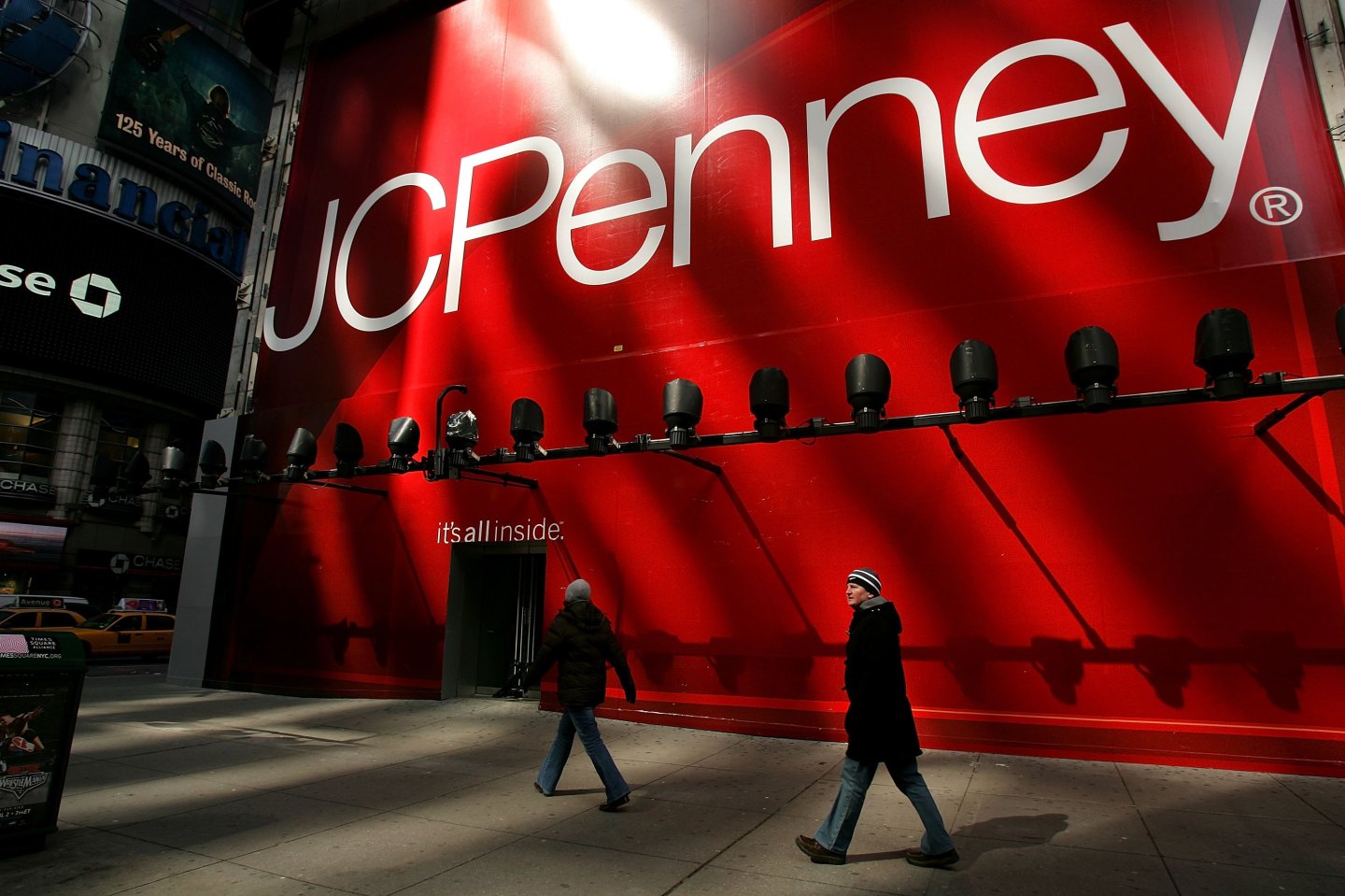NEW YORK - MARCH 03: Pedestrians walk past the new J.C. Penney 15,000-square foot temporary promotional store, or "pop-up" store, in Times Square March 3, 2006 in New York City. Part of the biggest marketing campaign of the retail stores 104 years in business, the store is an attempt to give the public a new and contemporary look at the chain. The store, which will only be opened for 24 days, features Warholesque style posters and plasma screen TV?s among 22 kiosks where customers can order merchandise, play games or download music. (Photo by Spencer Platt/Getty Images)