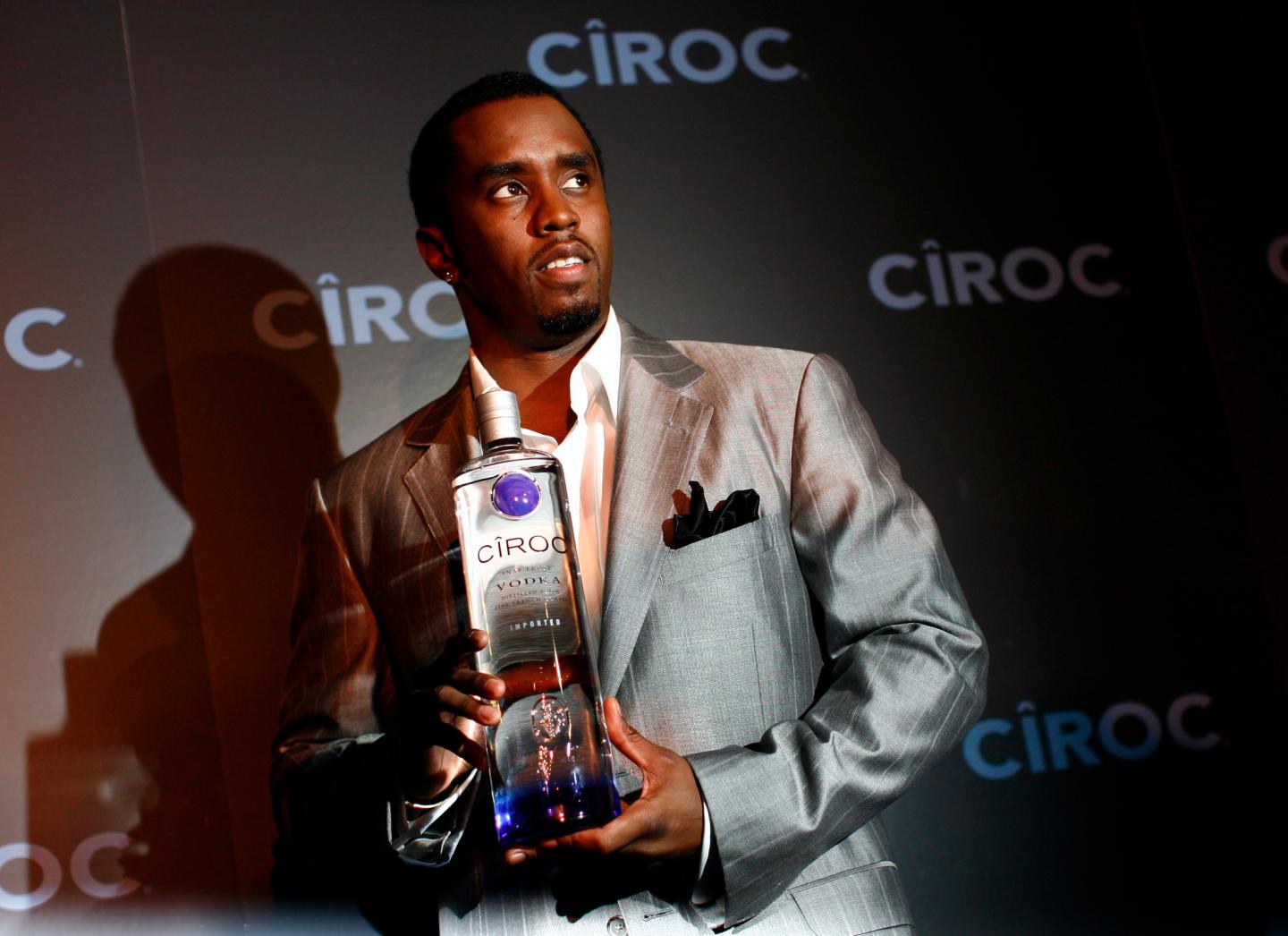 Sean "Diddy" Combs poses with a bottle of Ciroc vodka before a press conference announcing his alliance with the Diageo spirits company in New York