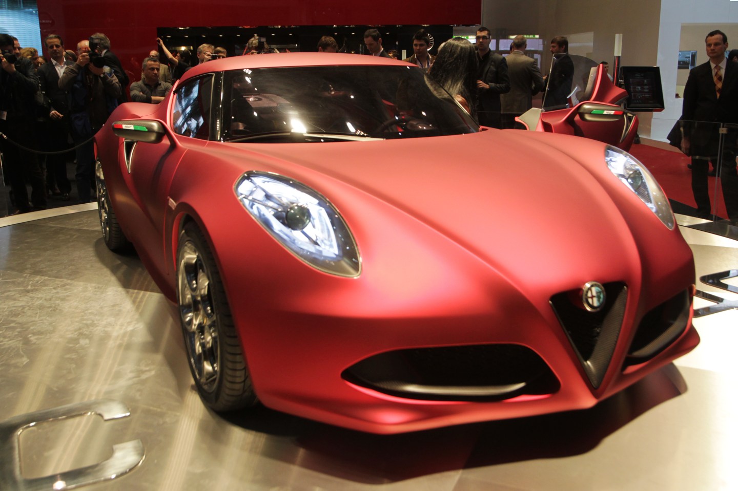 An Alfa Romeo 4C is displayed at the car