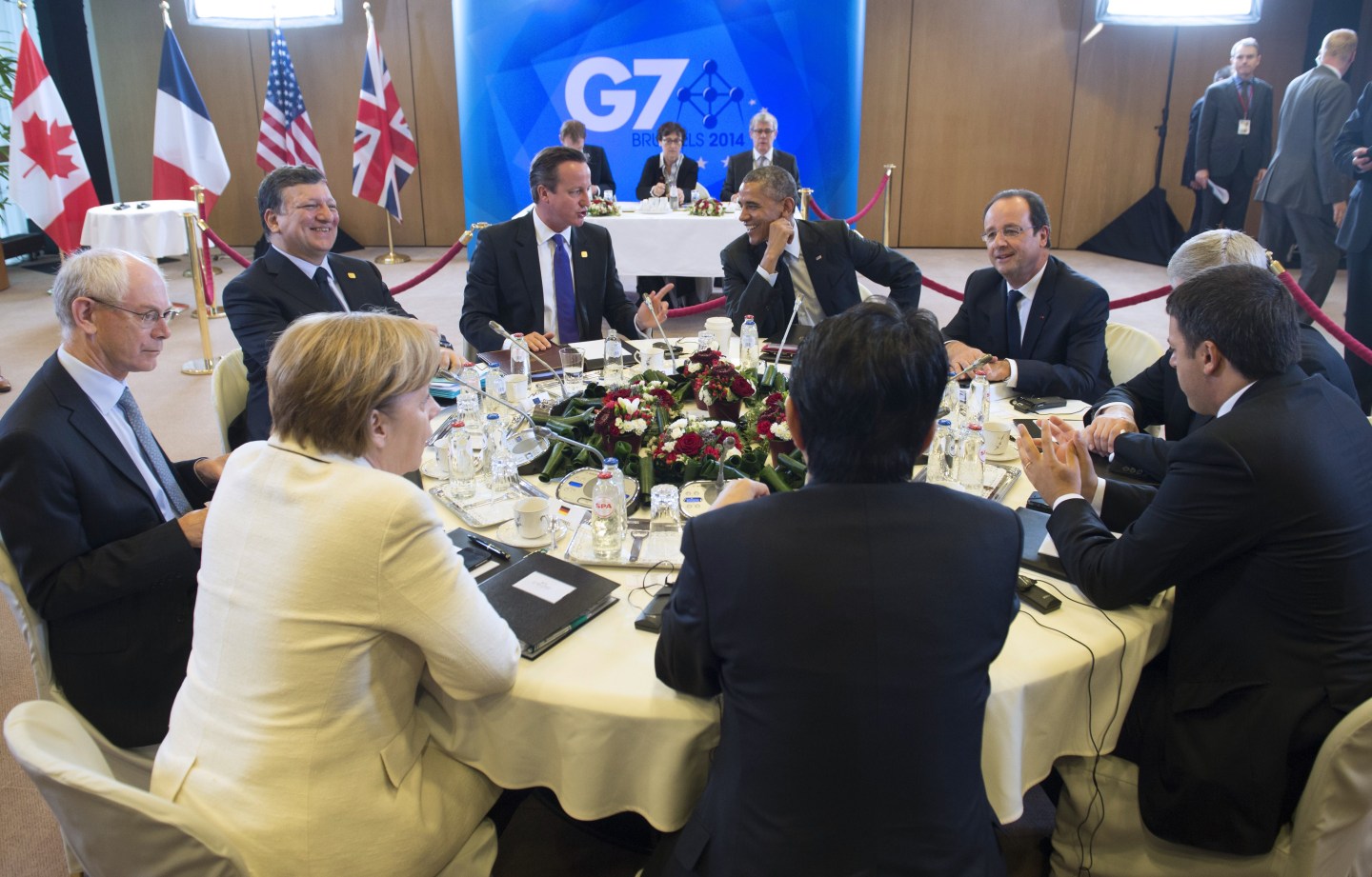 (clockwise) US President Barack Obama, French President Francois Hollande, Canadian Prime Minister Stephen Harper, Italian President Matteo Renzi, Japanese Prime Minister Shinzo Abe, German Chancellor Angela Merkel, President of the European Council Herman Van Rompuy, President of the European Commission Jose Manuel Barroso and British Prime Minister David Cameron participate in a session on the global economy during the G7 Summit at the European Council in Brussels, on June 5, 2014. AFP PHOTO / Saul LOEB (Photo credit should read SAUL LOEB/AFP/Getty Images)