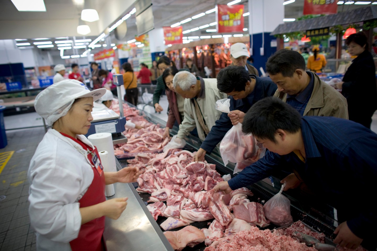 Customers select meat at a Wal-Mart Stores Inc. outlet in Be