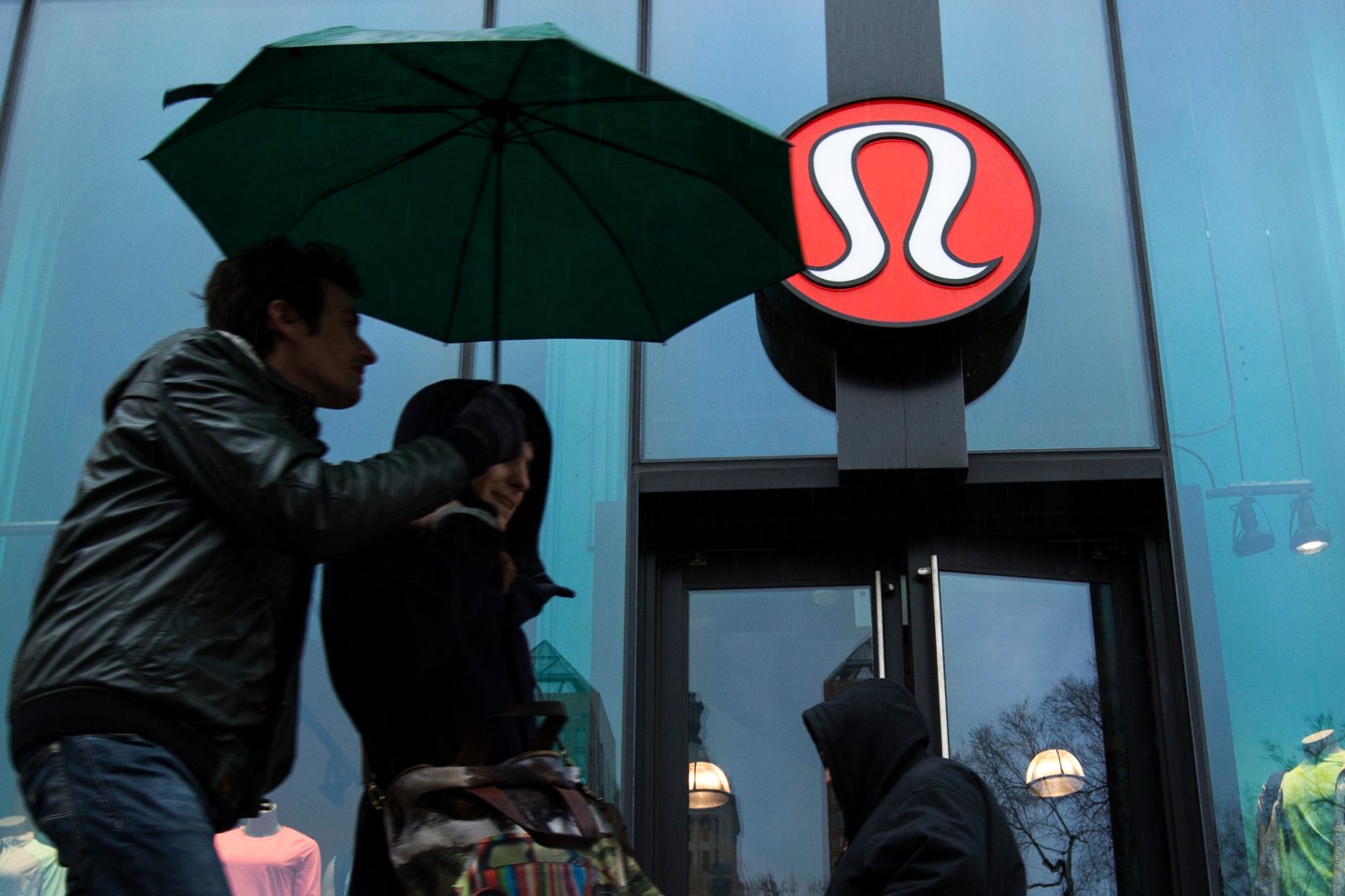 Pedestrians walk past a Lululemon Athletica store in New York