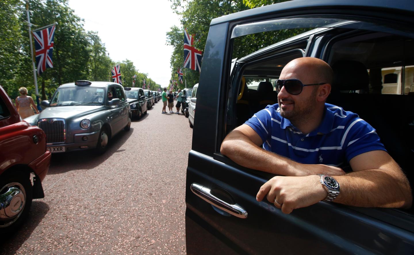 Taxi driver Joe Senatore joins other drivers during a demonstration along the Mall in central London