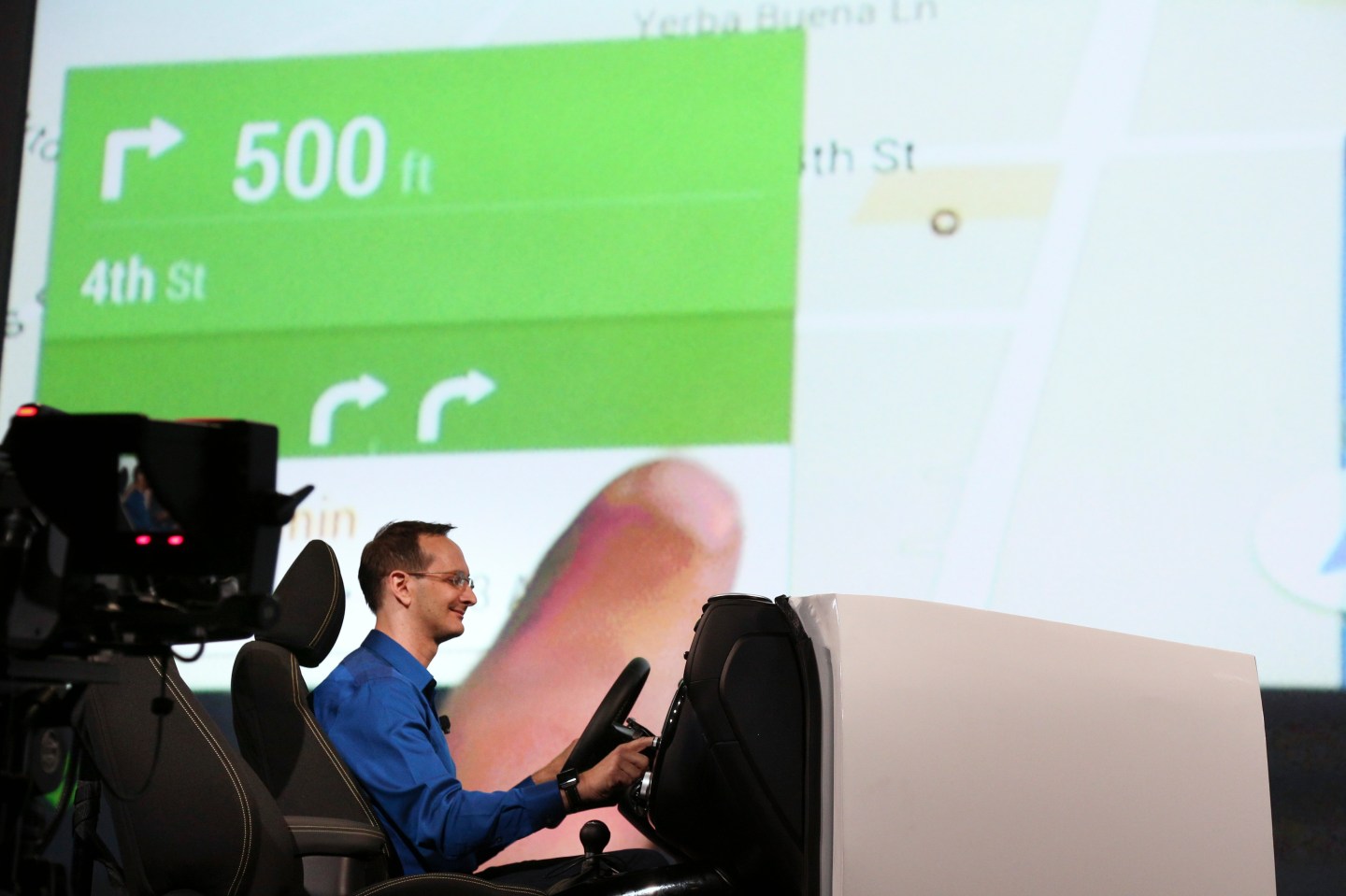 A Google employee demonstrates Android Auto onstage at the Google I/O developers conference in San Francisco