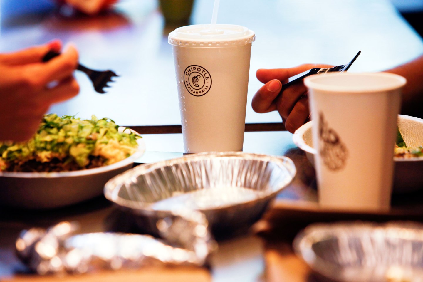 Customers eat at a Chipotle Mexican Grill Inc. restaurant in Hollywood, California, U.S., on Tuesday, July 16, 2013. Chipotle Mexican Grill Inc. is scheduled to release earnings data on July 18. Photographer: Patrick T. Fallon/Bloomberg via Getty Images