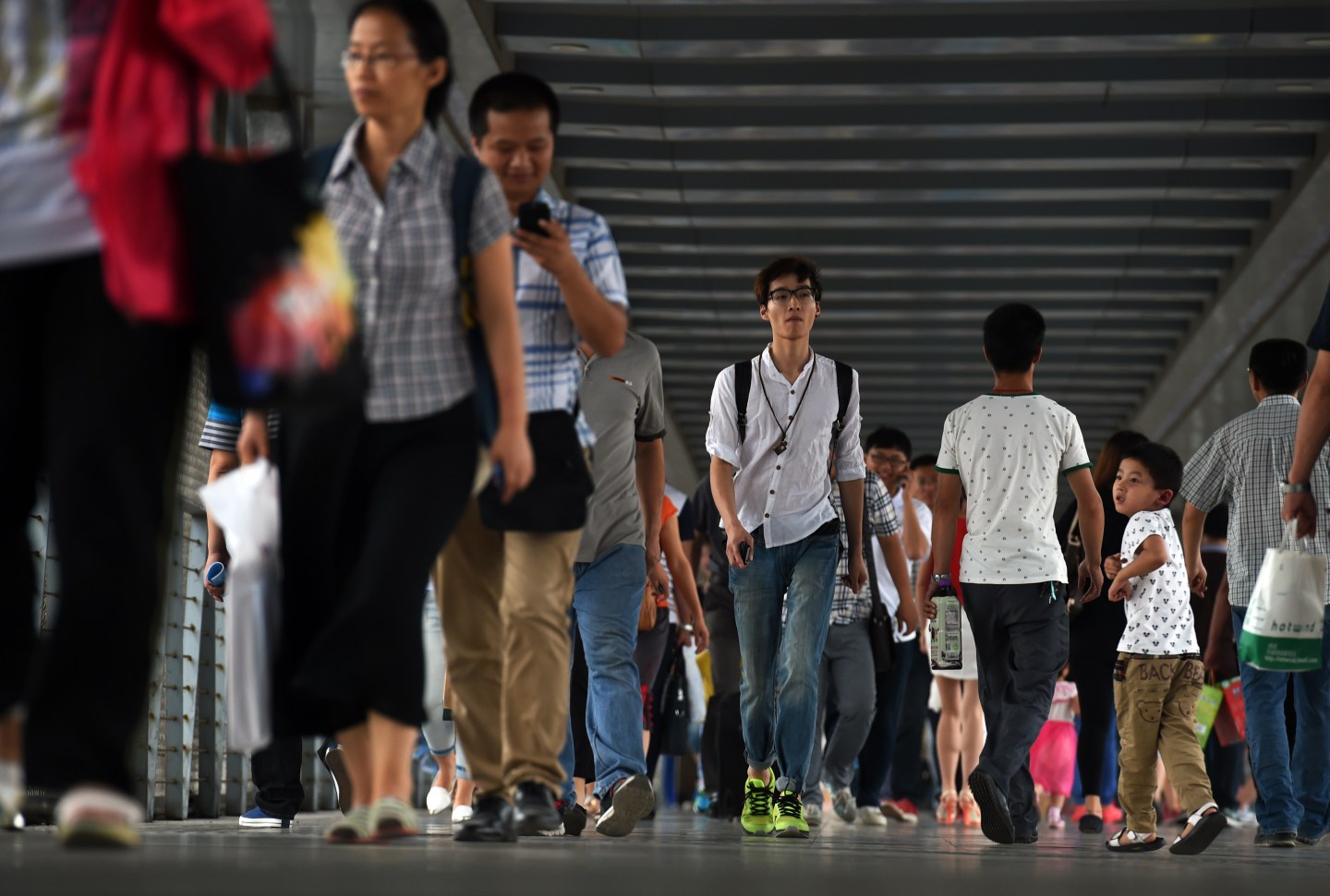 Chinese commuters cross a pedestrian bridge during rush hour in Beijing.