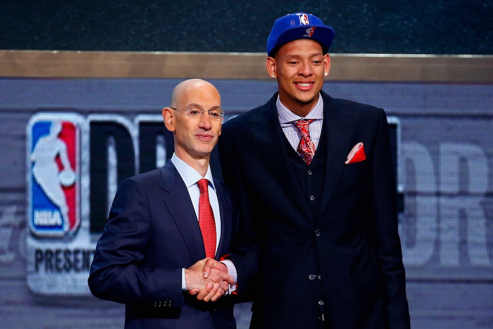 Isaiah Austin of Baylor (R) shakes hands with NBA Commissioner Adam Silver