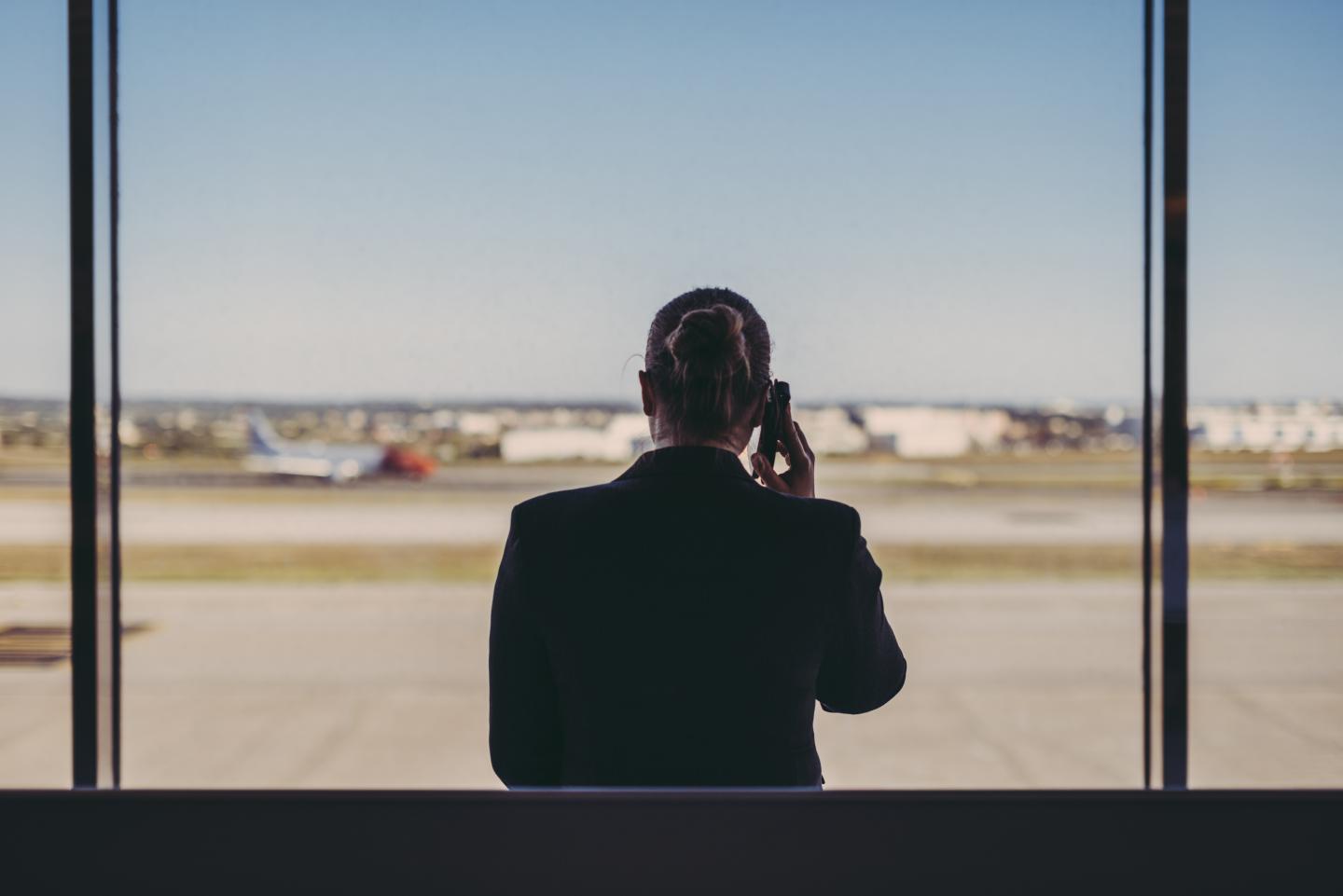 Business woman on phone at airport.