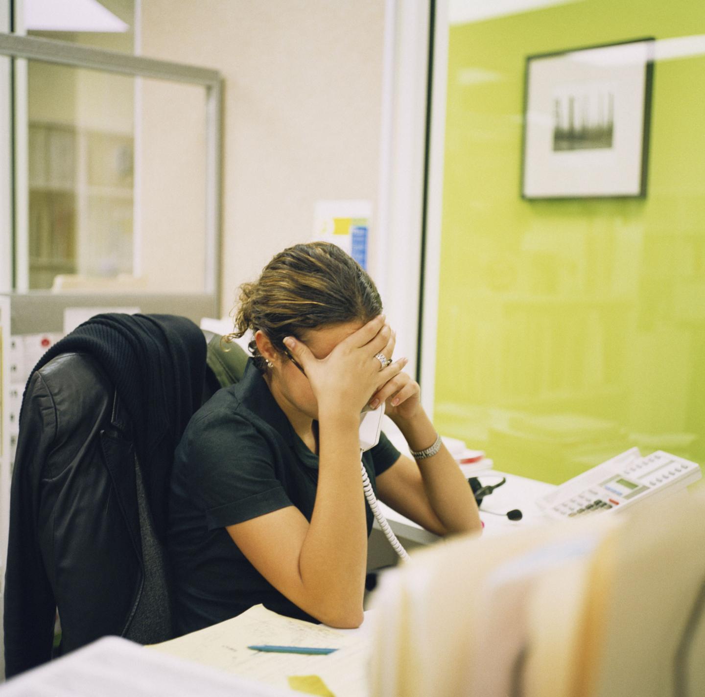 young woman frustrated at desk