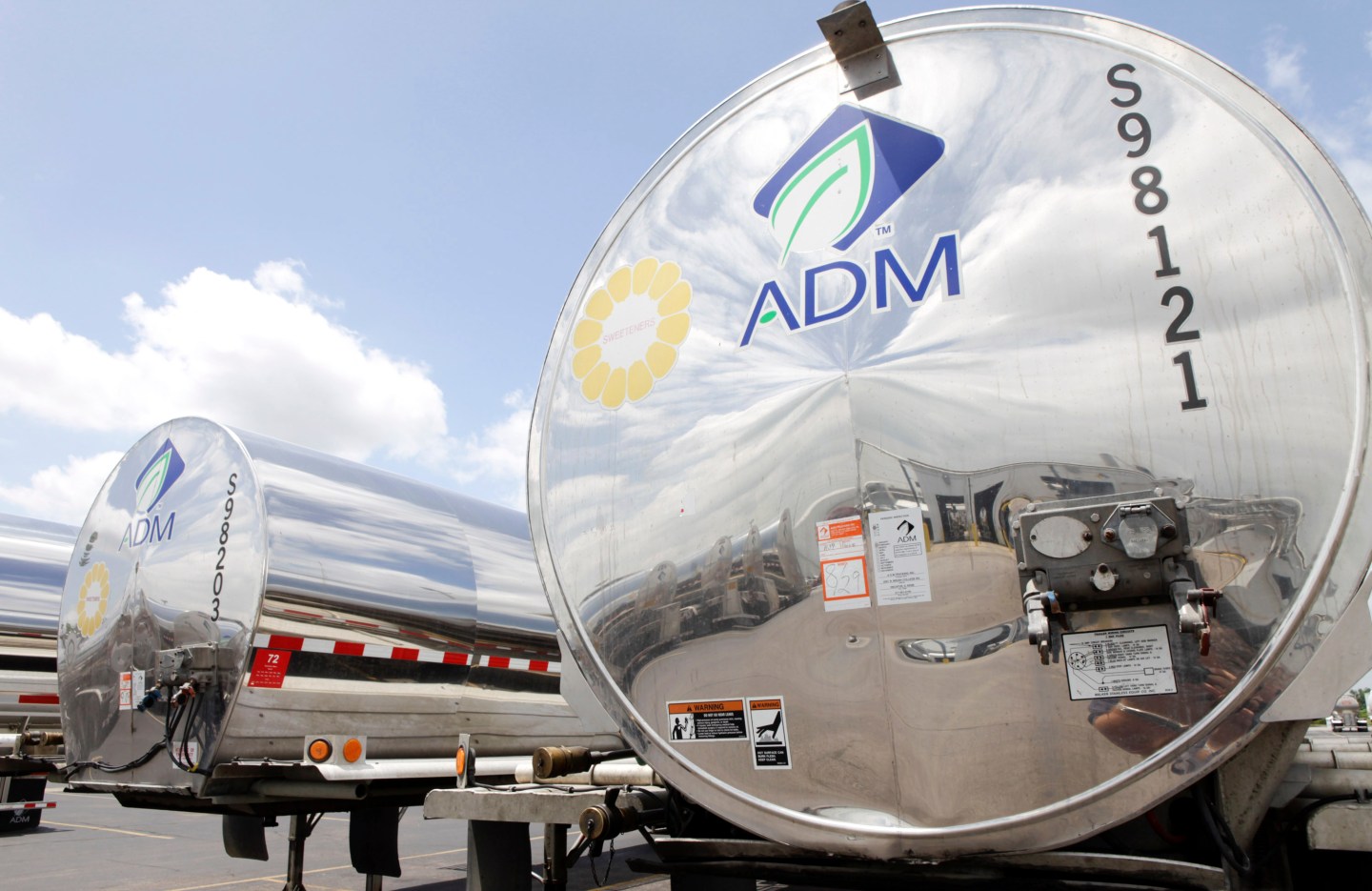 Sanitized trucks wait to be filled with corn syrup outside o