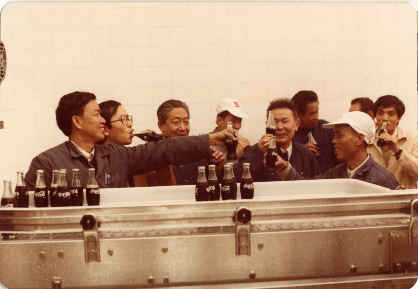 The management team enjoying the first batch of Coca-Cola produced at the Guangdong plant in 1983.