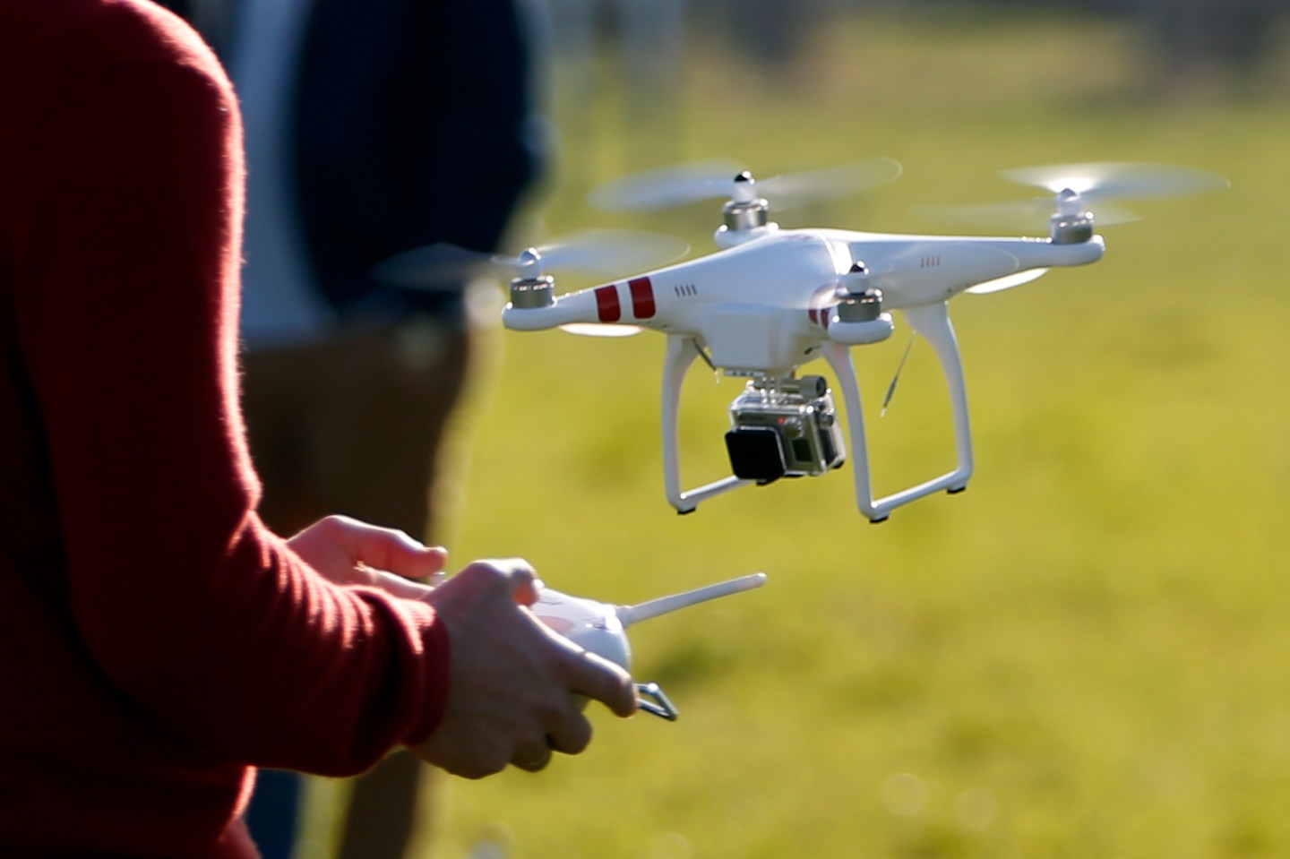 A pilot flies a Phantom drone by DJI company at the 4th Intergalactic Meeting of Phantom's Pilots in an open secure area in the Bois de Boulogne, western Paris