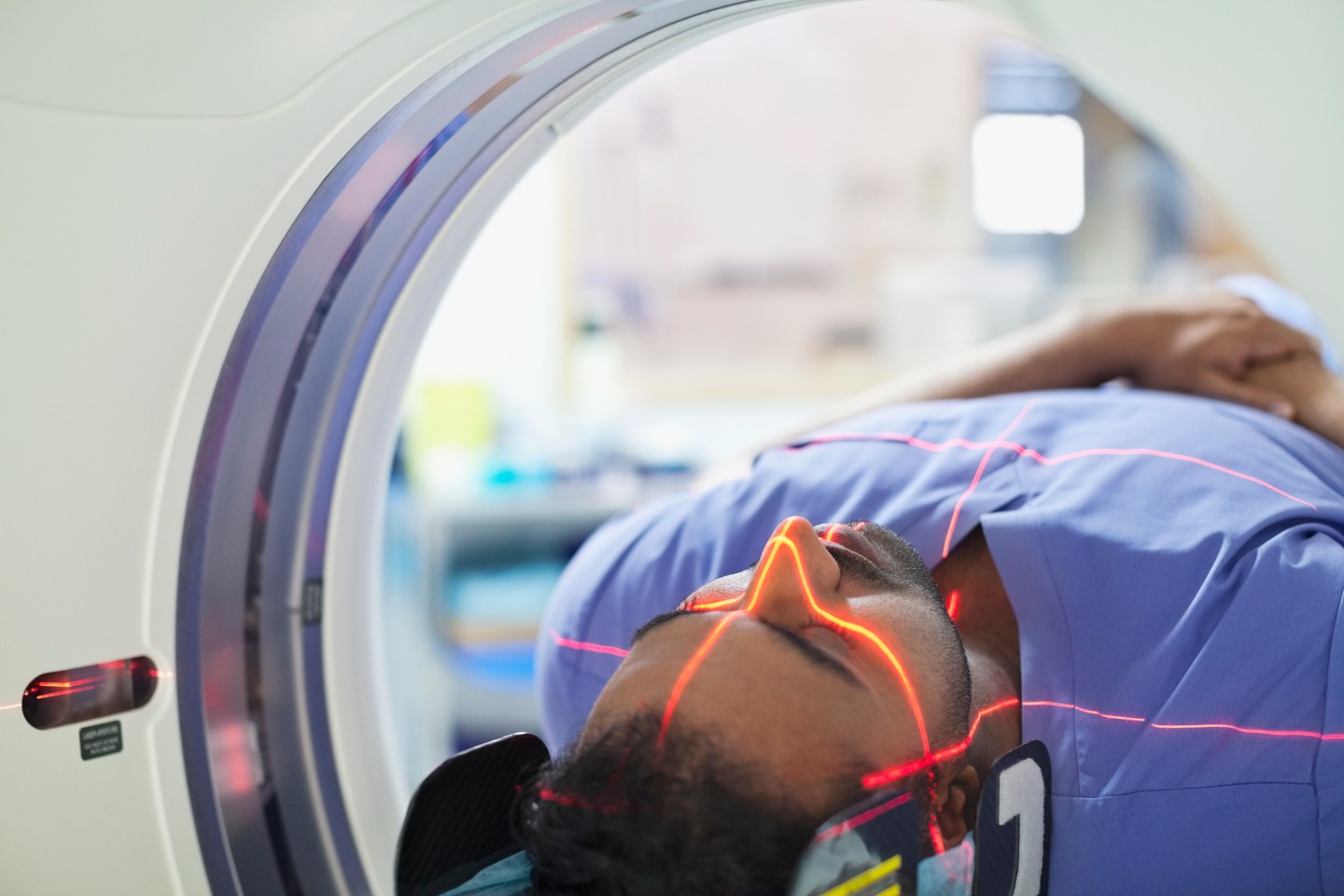 A male patient going through CT scan.
