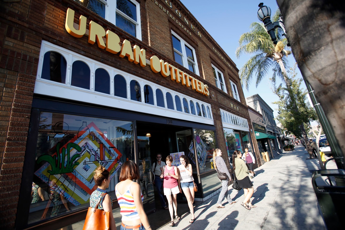 Shoppers are pictured outside a Urban Outfitters store in Pasadena