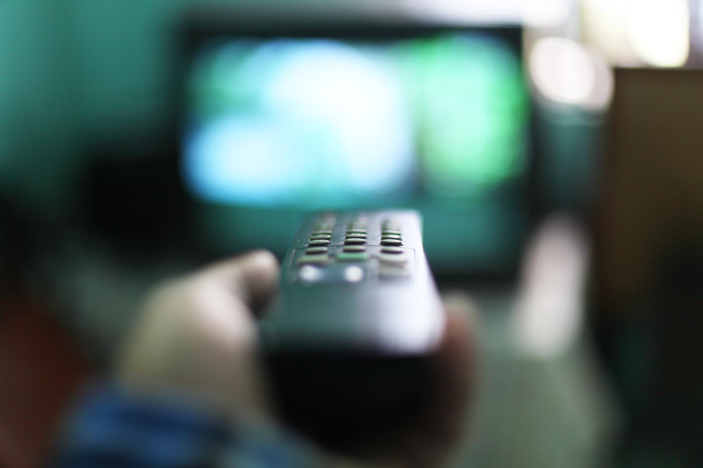 Human hand holding remote control