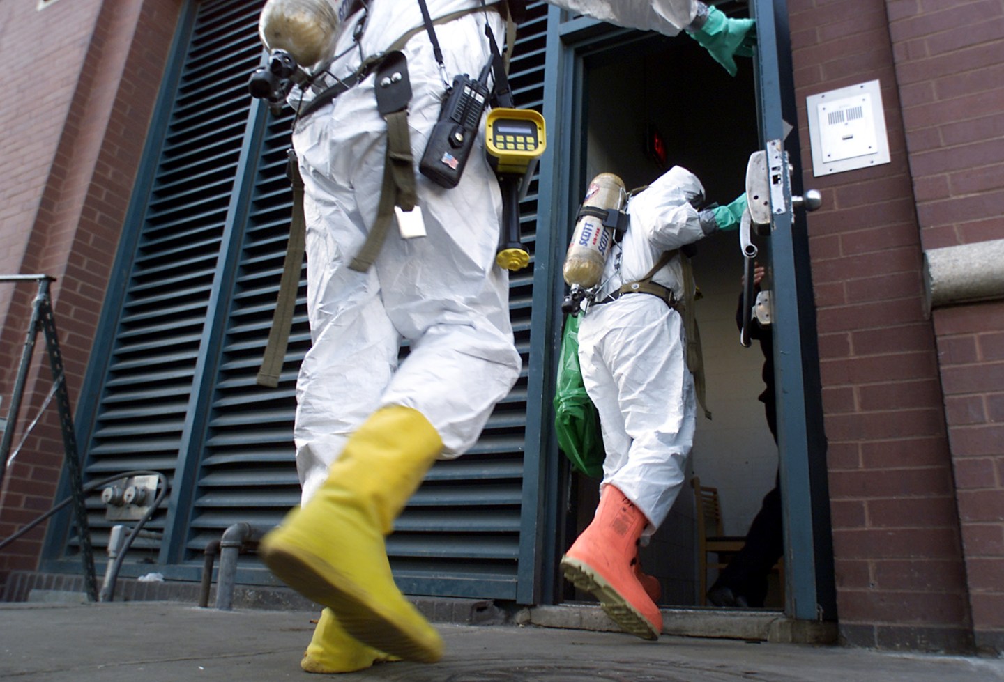 UNITED STATES - OCTOBER 19:  Firefighters in hazmat suits enter offices of Jefferies, Inc., in Jersey City, N.J., to investigate suspicious white powder found in an envelope.  (Photo by Mike Albans/NY Daily News Archive via Getty Images)
