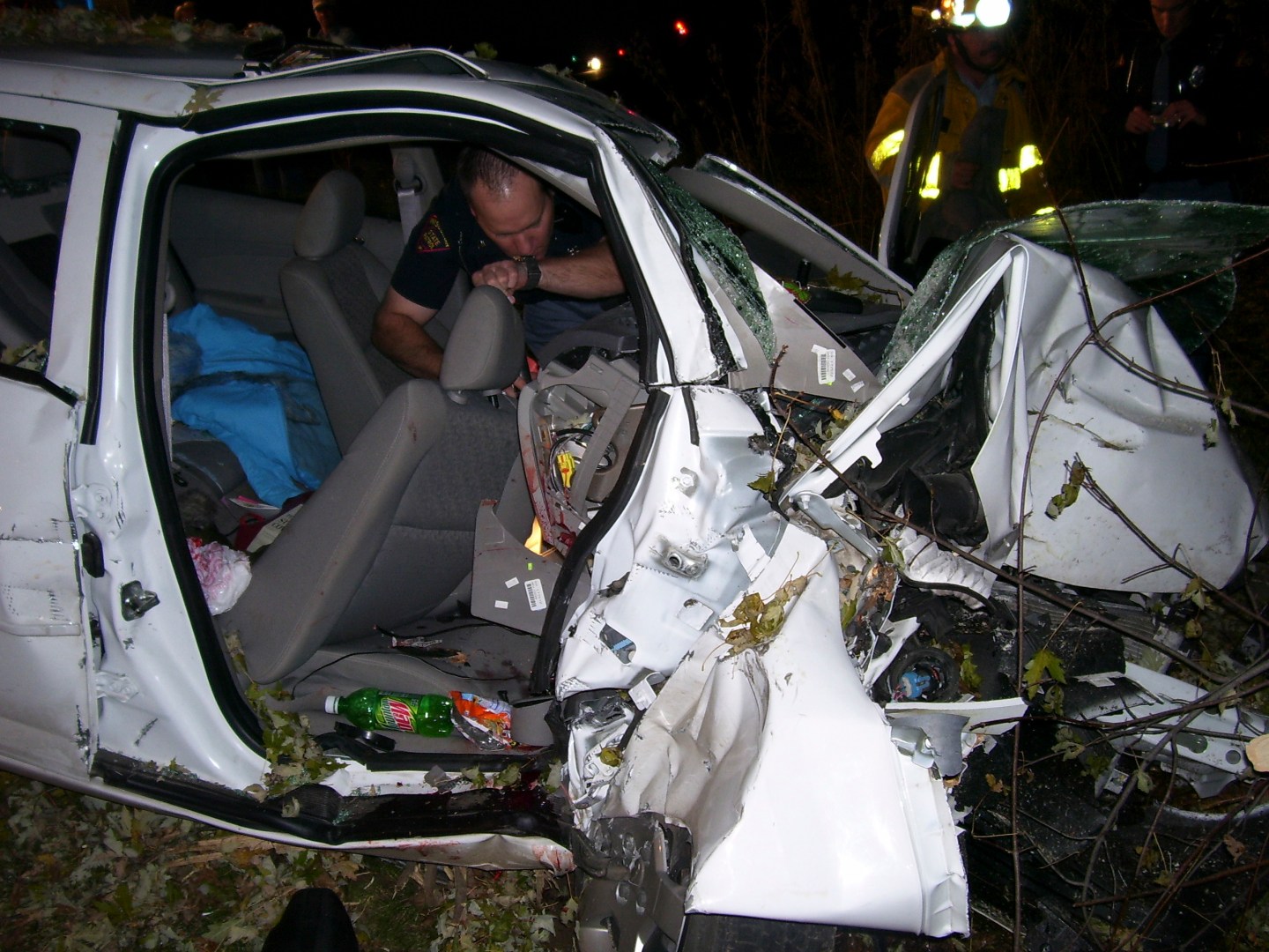 File photo of a police officer looking through the wreck of a 2005 Chevy Cobalt in St Croix County, Wisconsin