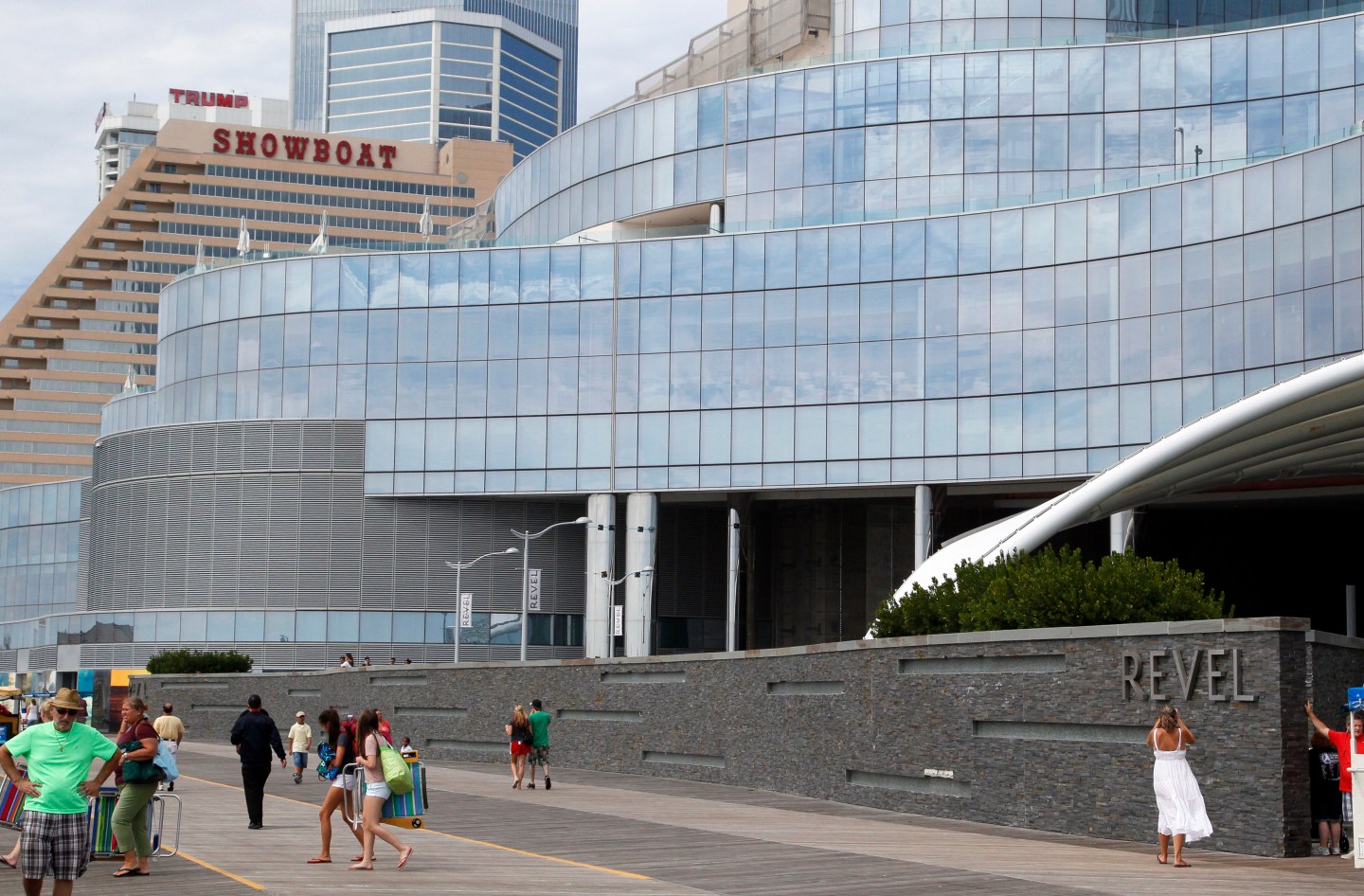 People walk outside the Revel Casino Hotel in Atlantic City