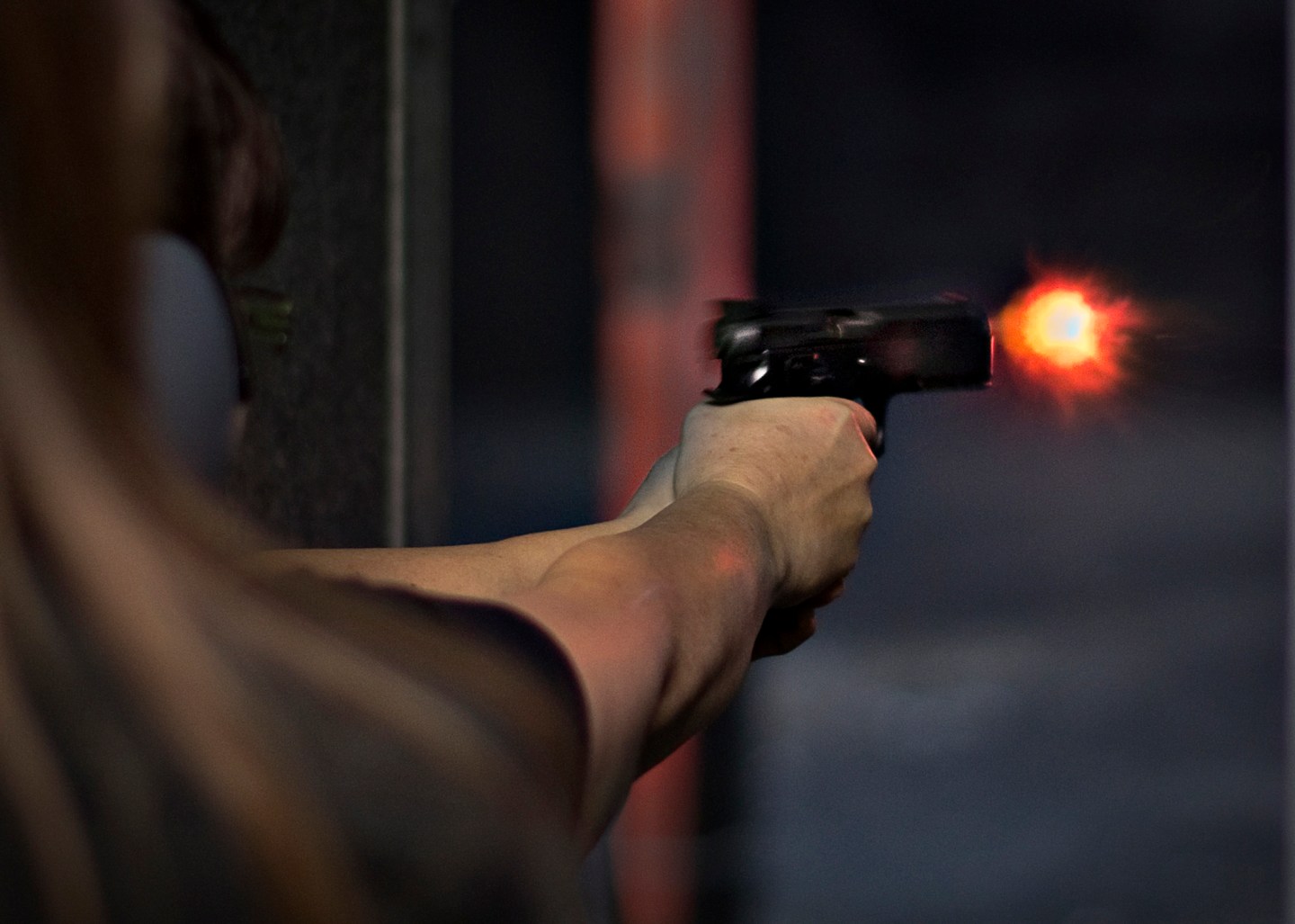 A visitor of DVC Indoor Shooting Centre fires a pistol on their range in Port Coquitlam, British Columbia