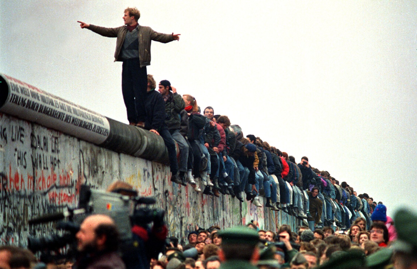 People Stand On The Berlin Wall