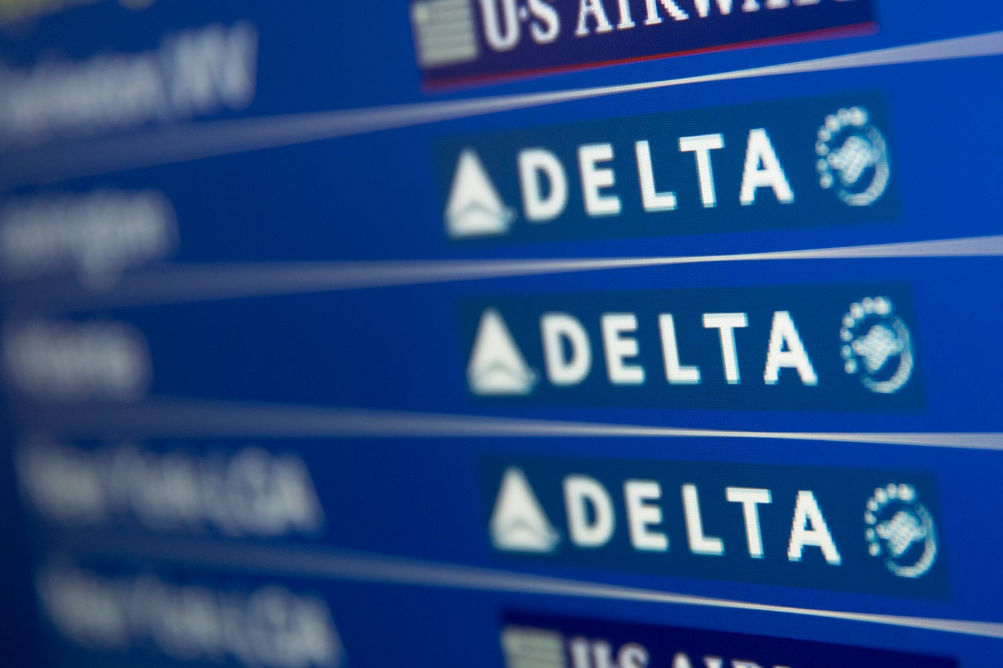 The Delta Air Lines Inc. logo is seen on the departures and arrivals screen at Ronald Reagan National Airport in Washington, D.C., U.S., on Friday, July 18, 2014. Delta Air Lines Inc., the third-largest U.S. airline, is expected to report second quarter earnings figures on July 23. Photographer: Andrew Harrer/Bloomberg via Getty Images