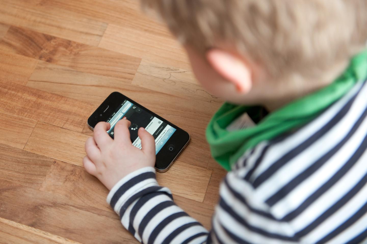 Boy playing with mobile phone