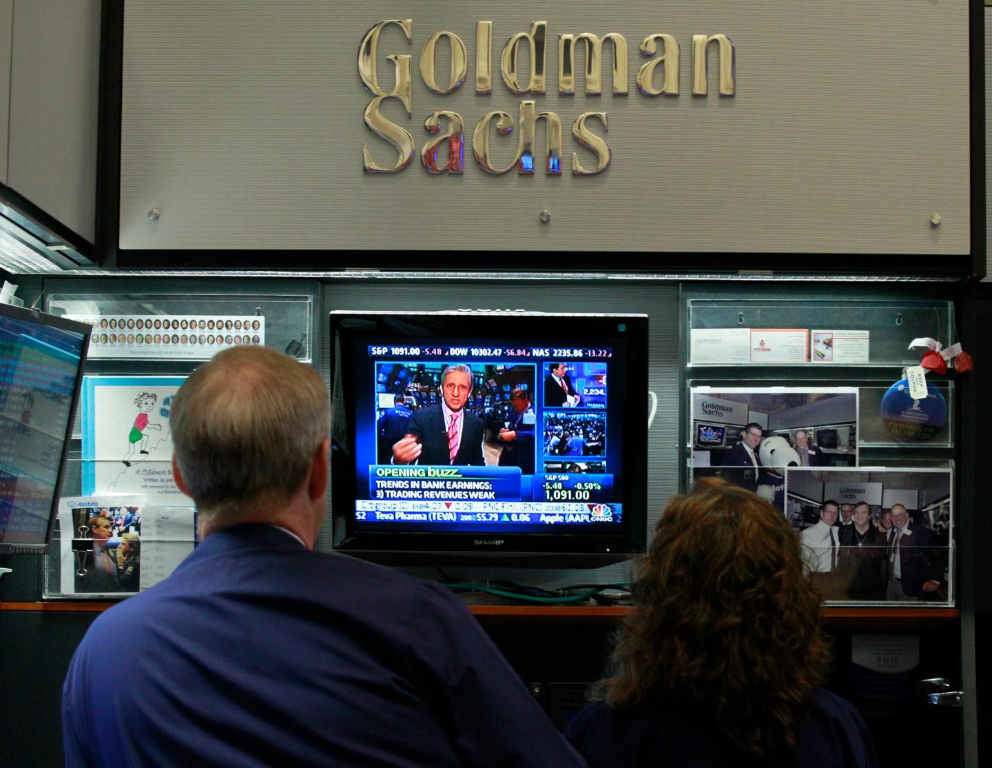 Traders work in the Goldman Sachs stall on the floor of the New York Stock Exchange
