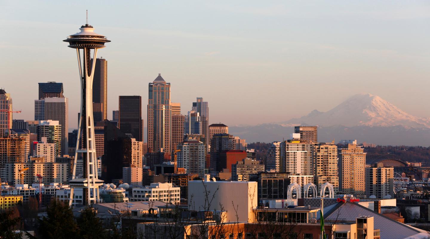The Space Needle and Mount Rainier are pictured at dusk in Seattle, Washington