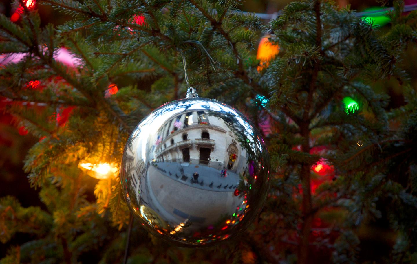 The New York Stock Exchange is pictured reflected in a Christmas Ornament in a tree in New York