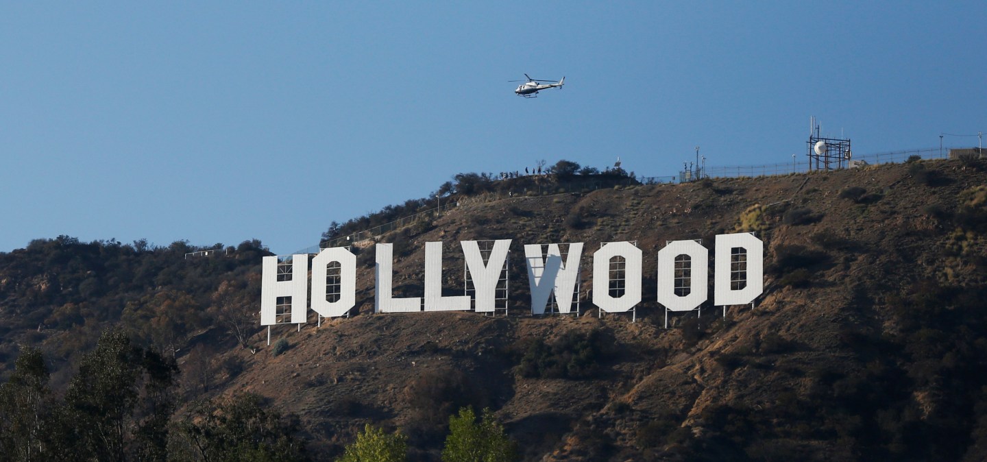 A LAPD helicopter flies over the Hollywood sign in Hollywood