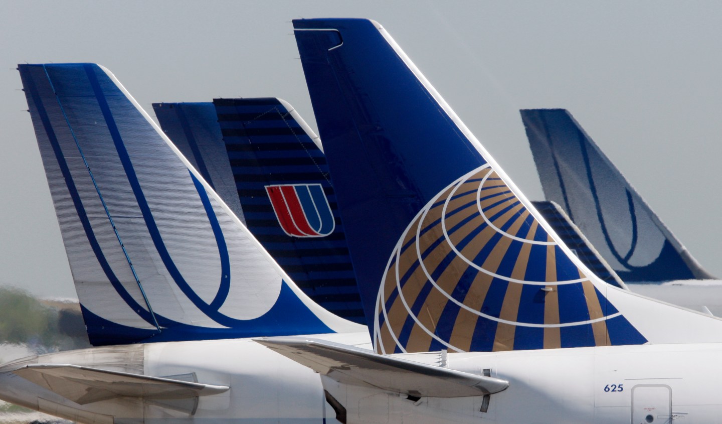 A Continental Airlines plane is parked next to United Airlines planes in Chicago